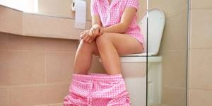 woman-sitting-on-toilet